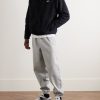 Solo Swoosh Tapered Logo-Embroidered Cotton-Blend Jersey Sweatpants - OU Solo Swoosh Tapered Logo-Embroidered Cotton-Blend Jersey Sweatpants - OU