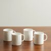 Set of Four Embossed Porcelain Mugs Set of Four Embossed Porcelain Mugs