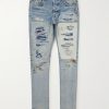 Skinny-Fit Logo-Embroidered Distressed Patchwork Jeans Skinny-Fit Logo-Embroidered Distressed Patchwork Jeans